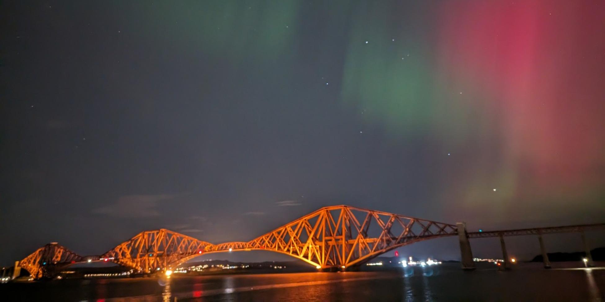 Northern Lights above the illuminated Forth Bridge