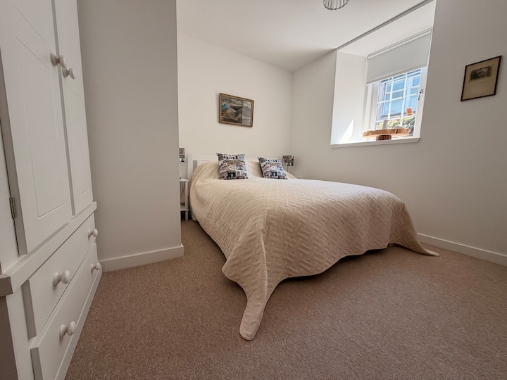 Second guest bedroom with a king-size bed and waterfront window